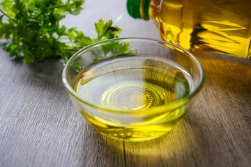 Cooking oil in a glass cup with cooking oil  on wooden background
