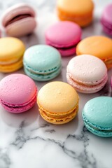 Obraz premium Colorful macarons arranged on marble surface, showcasing vibrant