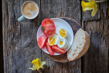 Breakfast,  boiled eggs, tomatoes, salad, sandwich, toast.