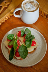 toast with cheese, cherry tomatoes and basil