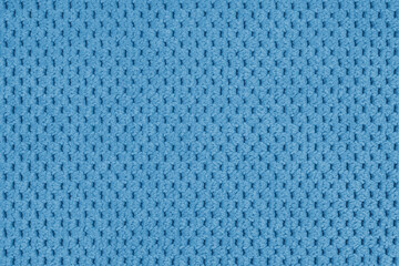 Plain blue velour upholstery fabric, fleecy jacquard with macro, closr up pattern weave texture background, cloth textile surface. Wallpaper, backdrop with copy space