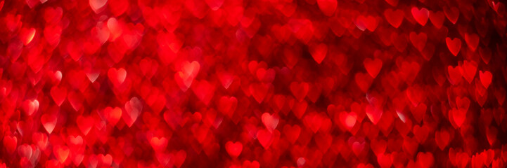 Red hearts, sparkling glitter bokeh background banner, valentines day abstract defocused texture header.