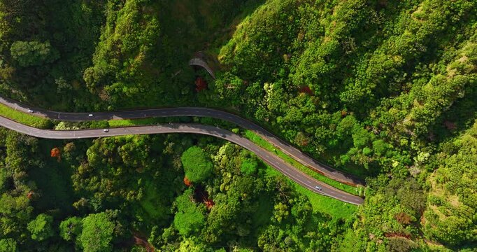 Two parallel highways crossing the mountains. Aerial perspective on the roads passing the picturesque nature in the rocks.