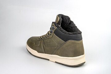 Image showcases a single rugged, dark greenolive suede boot with white stitching and laces, gray midsole, and no visible branding Professional product photo style for online retail or promotions