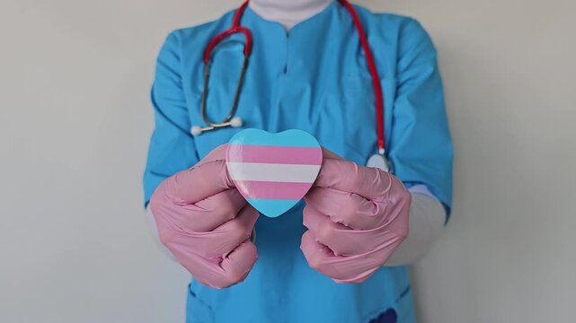 Healthcare worker supports transgender community with heart symbol in a medical setting