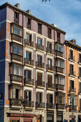 This is a tall building that features numerous windows and balconies