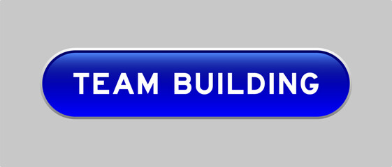 Blue color capsule shape button with word team building on gray background