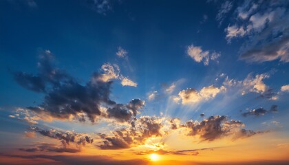 Fototapeta premium Sky at sunset blue and orange light of the sun through the clouds in the sky