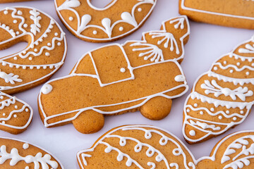 Gingerbread decorated with white sugar glaze. Food background. Christmas tree cookies. Winter Car track shape