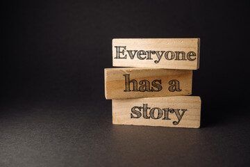 Three wooden blocks stacked on top of each other with the words "everybody has a