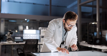 Scientist, man and test with screen for lab review, medical research or innovation. Computer table, interactive display and clinical analysis for studying science data, laboratory and results