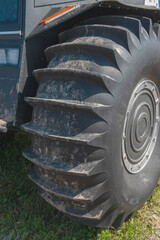 ATV - all-terrain vehicle wheel tread close-up. The large tread pattern of the wheel is the key to...