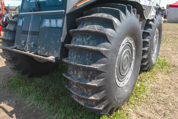 ATV - all-terrain vehicle wheel tread close-up. The large tread pattern of the wheel is the key to...
