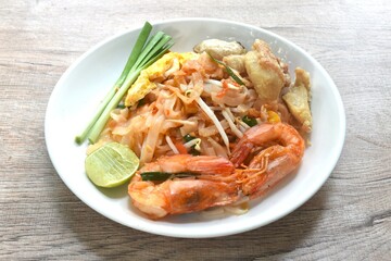 Pad Thai stir fried rice noodles with shrimp and egg on plate 