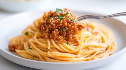 A plate of spaghetti topped with rich tomato meat sauce, garnished with fresh herbs, close-up shot on a white background, and delicious Italian cuisine concept.