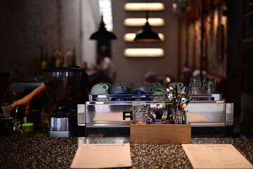 A slightly blurred interior shot focuses on the coffee preparation area inside a cafe.