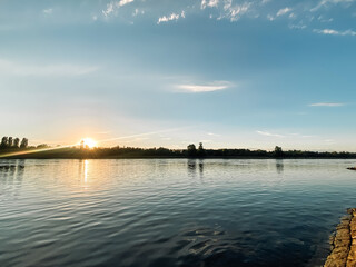 Beautiful blue ocean with a sun setting in the background