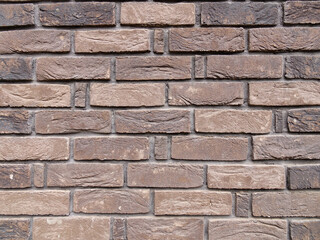 Element of the facade of a building covered with decorative brick, background