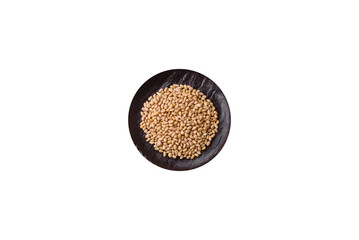 Peeled pine nuts in a bowl on a white background