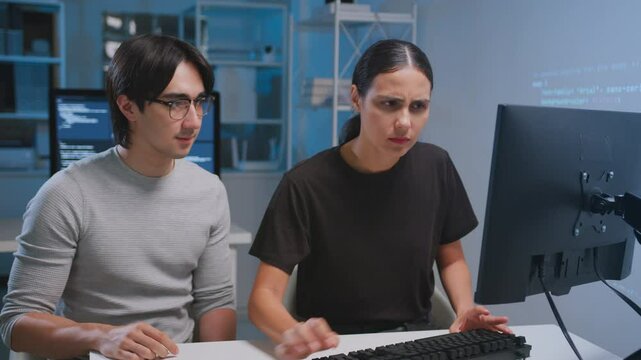 Two developers collaborating coding and software tasks modern workspace, utilizing teamwork and technology with programming computer monitor and tablet for coding developer software programmer code