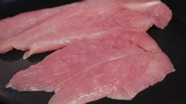 Cooking turkey breast on pan close-up. Preparing healthy dinner at home. High quality 4k footage