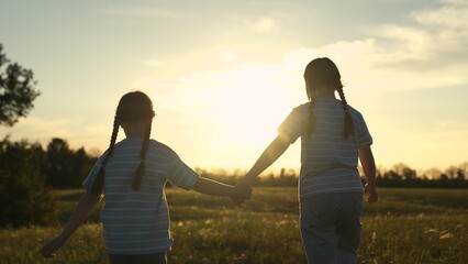 Two child sister girl kid holding hands field sunset, siblings watching sunset together, children...