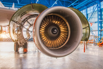 Jet passenger aircraft engine close up view with illuminated blades during repair and maintenance...