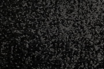black sequin fabric texture. pattern of material with sequin in the light