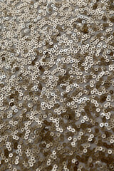 gold sequin fabric texture. pattern of material with sequin in the light golden color