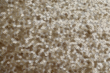 gold sequin fabric texture. pattern of material with sequin in the light golden color