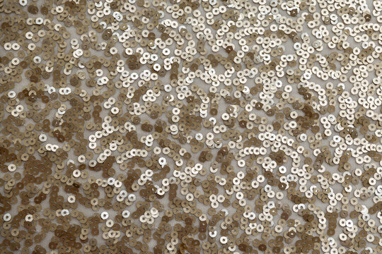 gold sequin fabric texture. pattern of material with sequin in the light golden color
