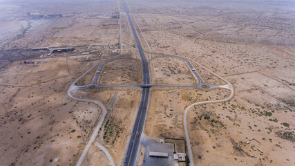 Aerial view of hyderabad motorway intersecting arid desert landscape, hyderabad, sindh, pakistan.