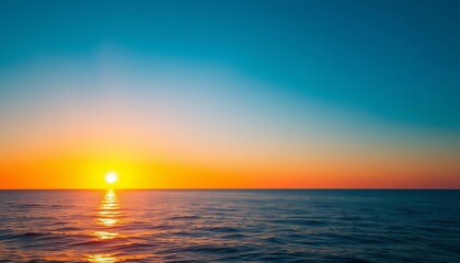 Obraz premium Sunrise over a blue ocean, orange hues reflecting on the water, beach, morning