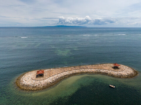 Aerial view of karang beach with turquoise water and clear sky, Denpasar Selatan, Bali, Indonesia.