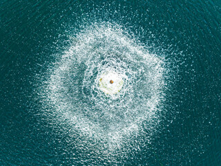 Aerial view of serene blue ocean waves creating dynamic patterns, La Noria Golf Resort, Mijas, Malaga, Spain.