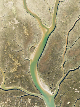 Aerial view of Isla Canela marshland with serpentine river and unusual patterns, Ayamonte, Huelva, Spain.