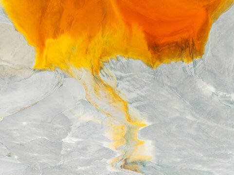 Aerial view of abstract forms and colorful patterns in vibrant orange, yellow, and gray, El Campillo, Huelva, Spain.