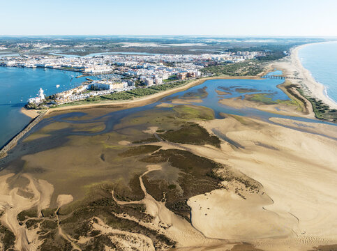 Aerial view of beautiful coastal landscape with sandy beach and urban town, Isla Cristina, Huelva, Spain.