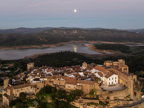 Aerial view of Castillo de Castellar surrounded by picturesque mountains and a scenic river at sunset, Castellar de la Frontera, Cadiz, Spain.