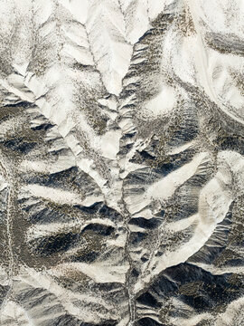 Aerial view of beautiful farmland with abstract patterns and rugged terrain, Dehesas de Guadix, Granada, Spain.
