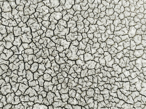 Aerial view of cracked earth with dry texture and rugged patterns, Sanlucar de Barrameda, Cadiz, Spain.