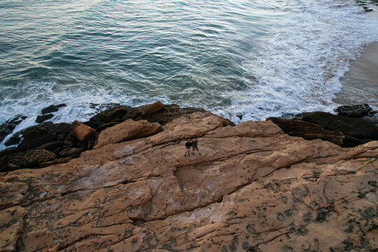 Aerial view of beautiful cliff beach with rugged rocks and tranquil sea, Algave, Portugal.