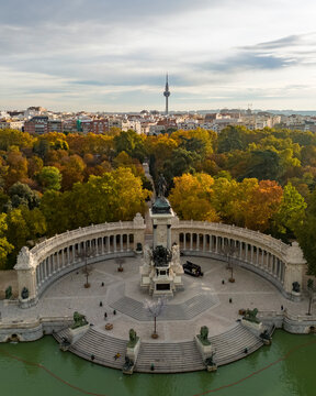 Aerial view of Parque el Retiro with Monumento a Alfonso XII surrounded by trees and water, Madrid, Madrid, Spain.