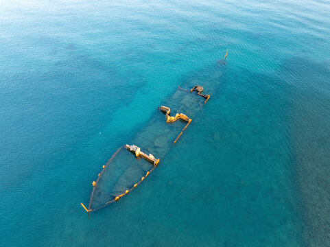 Aerial view of a tranquil shipwreck submerged in clear blue ocean waters, Bain des Dames, Port Louis, Mauritius.