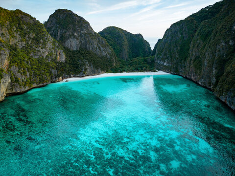 Aerial view of maya bay with turquoise water, cliffs, and sandy beach, phi phi island, thailand.