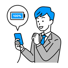 スマートフォンを充電するスーツの男性