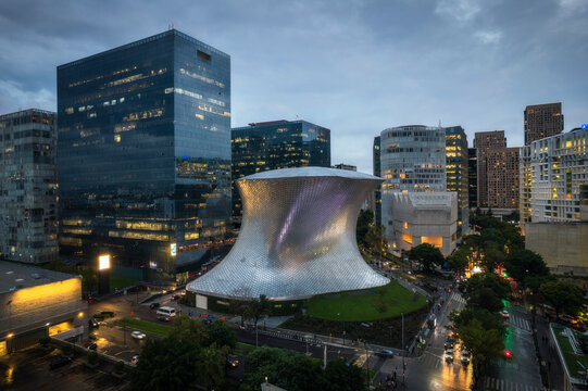 Aerial view of soumaya museum and modern skyscrapers with city lights in evening, Miguel Hidalgo, Mexico City, Mexico.