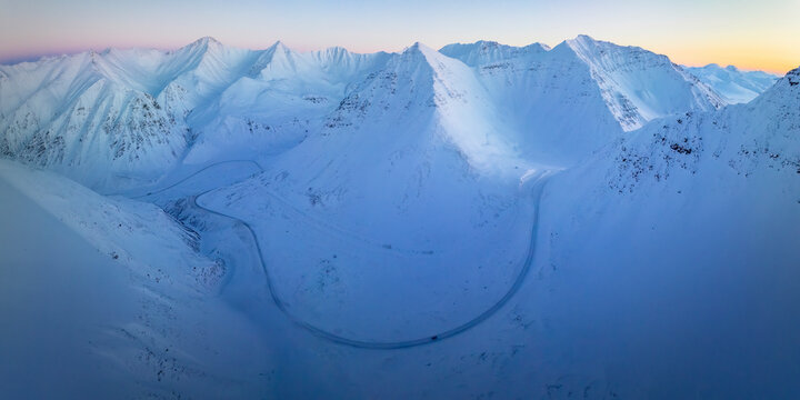 Aerial view of winter mountain pass in alaska tundra with beautiful snow landscape, Nuiqsut, Alaska, United States.