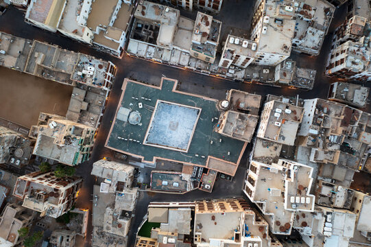 Aerial view of historic mosque and ancient buildings with intricate rooftops in the old town, Al Balad, Jeddah, Mecca, Saudi Arabia.