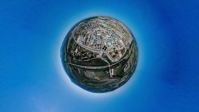 Aerial view of a tiny planet perspective of the urban landscape with beautiful architecture and historic landmarks, San Fulgencio, Alicante, Spain.